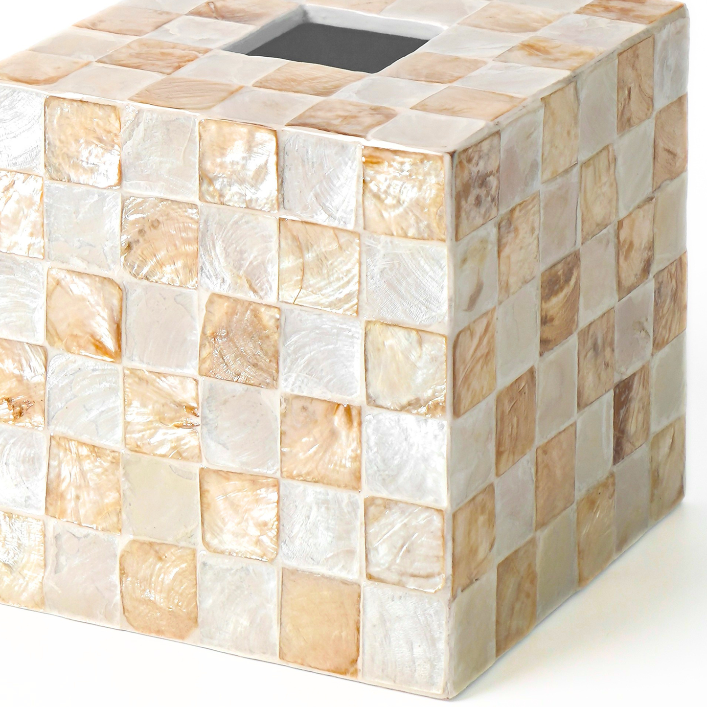 Close up of a square decorative tissue box holder with capiz shells tiles, iridescent featuring a square opening on top, shown on a white background.