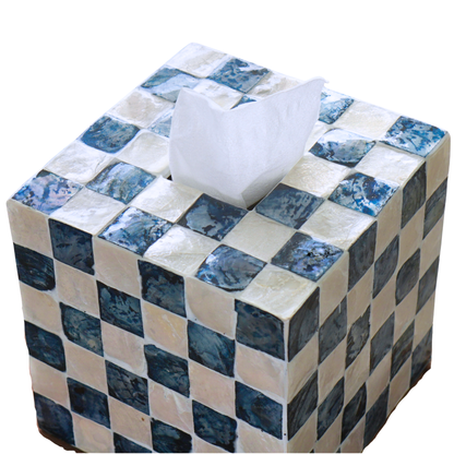 A square tissue box cover made of blue and cream checkered capiz shells tiles, with a white tissue paper protruding from the top, isolated on a white background.